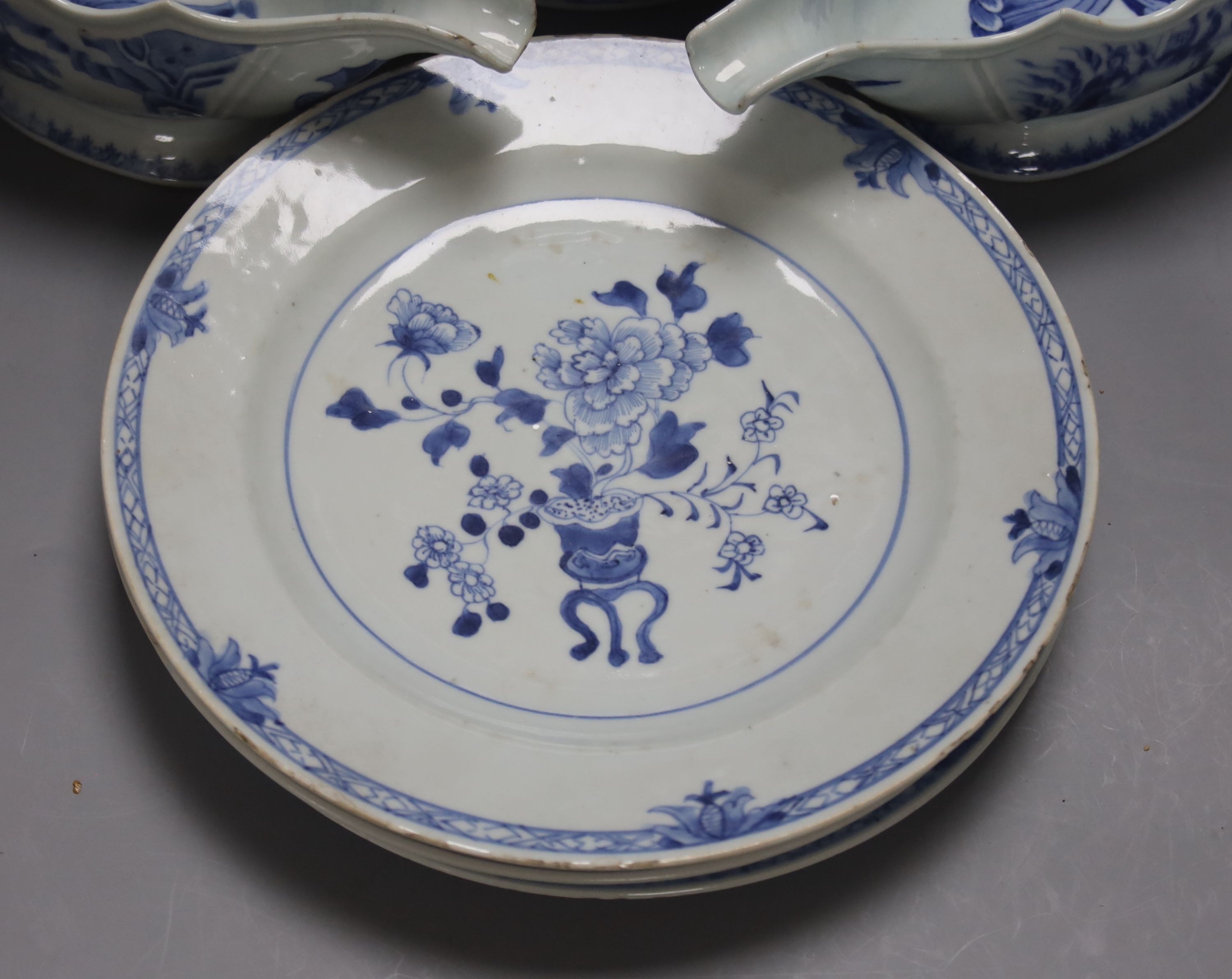 An 18th century Chinese Export blue and white octagonal tureen and cover, decorated with birds and flowers, a pair of similar sauceboats and five plates decorated with urns of flowers